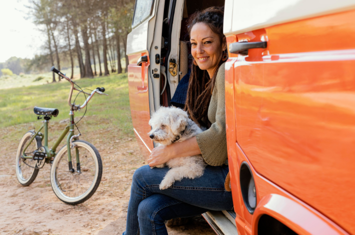 Foto de uma mulher com um cachorro dentro de uma van