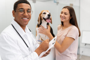 Um veterinário junto a um cachorro e sua dona